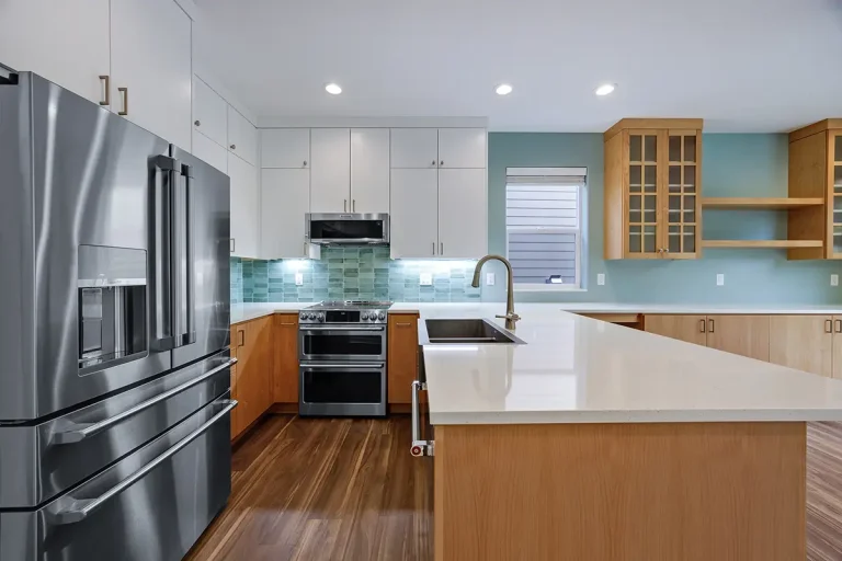 green-seashell-wall-metallic-fridge-white-coutnertops-and-wood-cabinets-kitchen-remodel-by-pdx-remodeling-and-design