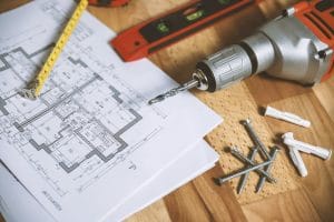 a photo of a drill and a blueprint for a whole home remodel in the portland, oregon area